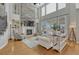 Spacious living room with hardwood floors, a stone fireplace, and large windows at 26566 E Peakview Dr, Aurora, CO 80016