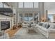 Cozy living room featuring a stone fireplace, lots of natural light and neutral decor at 26566 E Peakview Dr, Aurora, CO 80016