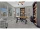 Well-lit office with large windows, built-in bookshelves, and a spacious work area at 26566 E Peakview Dr, Aurora, CO 80016