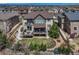 Aerial shot of the home's rear exterior featuring a landscaped yard and a spacious deck at 26566 E Peakview Dr, Aurora, CO 80016