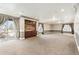 Expansive basement with built-in shelving and large windows, offering natural light at 4913 Cathay Ct, Denver, CO 80249