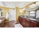 Bathroom features double sink vanity, soaking tub, and earth-tone tile flooring at 4913 Cathay Ct, Denver, CO 80249