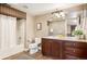 Bathroom boasts a shower-tub combo with a large vanity and decorative mirror at 4913 Cathay Ct, Denver, CO 80249