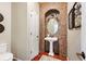 Elegant powder room boasting a pedestal sink, mosaic tile accent wall, and decorative fixtures at 4913 Cathay Ct, Denver, CO 80249