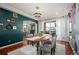 Bright dining room with modern chandelier, a wooden table, and easy access to the outdoor balcony at 4913 Cathay Ct, Denver, CO 80249