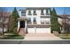 Two story stucco house with a two car garage and brick paved driveway with red brick stairs leading to the entrance at 4913 Cathay Ct, Denver, CO 80249
