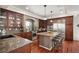 Well-appointed kitchen with granite countertops, an island with seating, and stainless steel appliances at 4913 Cathay Ct, Denver, CO 80249