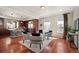 Open concept living room connected to the kitchen offering natural light and hardwood floors at 4913 Cathay Ct, Denver, CO 80249