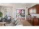 Open-concept living area with hardwood floors, view to dining area, and cozy furniture at 4913 Cathay Ct, Denver, CO 80249
