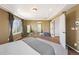 Main bedroom with carpet, neutral paint, tray ceilings, and ensuite bathroom at 4913 Cathay Ct, Denver, CO 80249