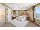 Spacious bedroom features a tray ceiling, recessed lights, and large window with natural light at 4913 Cathay Ct, Denver, CO 80249