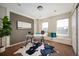Home office features a modern desk, bright windows, and a decorative cowhide rug at 4913 Cathay Ct, Denver, CO 80249