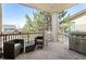 Cozy covered patio featuring comfortable seating, a grill, and views of the surrounding landscape at 4913 Cathay Ct, Denver, CO 80249