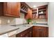 Elegant wet bar featuring custom wood cabinetry, wine rack, and ample counter space at 4913 Cathay Ct, Denver, CO 80249
