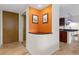 Stylish entryway featuring a display niche with colorful orange accent wall and convenient access to kitchen at 1150 Vine St # 306, Denver, CO 80206