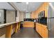 Efficient galley kitchen offers warm wood cabinetry, stainless steel appliances, and ample countertop prep space at 1150 Vine St # 306, Denver, CO 80206