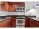 Detailed view of a kitchen with stainless steel oven, sleek countertops, and custom wood cabinets at 1150 Vine St # 306, Denver, CO 80206