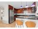 Well-appointed kitchen with stainless steel appliances, barstool seating, and ample counter space at 1150 Vine St # 306, Denver, CO 80206