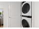 Modern, stacked washer and dryer unit inside a closet with a white door is perfect for space-saving and convenient laundry at 1150 Vine St # 306, Denver, CO 80206