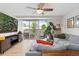 Inviting living room with a cozy gray couch, balcony access, and entertainment center with a large screen TV at 1150 Vine St # 306, Denver, CO 80206