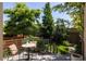 Backyard deck with seating nestled among lush greenery and trees at 3130 Wyandot St, Denver, CO 80211