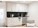 Wet bar featuring marble backsplash, sleek cabinets, gold hardware, and wine fridge at 3130 Wyandot St, Denver, CO 80211