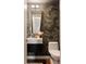 Stylish powder room featuring designer wallpaper, a modern vanity, and brushed gold finishes at 3130 Wyandot St, Denver, CO 80211