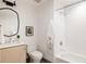 Well-lit bathroom featuring a modern vanity, sleek mirror, and tiled shower at 3130 Wyandot St, Denver, CO 80211