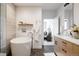 Elegant bathroom showcasing a soaking tub, modern vanity, and access to the main bedroom at 3130 Wyandot St, Denver, CO 80211