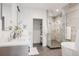 Modern bathroom with a glass-enclosed shower, soaking tub, and dual sink vanity at 3130 Wyandot St, Denver, CO 80211