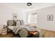 Comfortable bedroom featuring a decorative rug, a wooden accent bench, and a large window at 3130 Wyandot St, Denver, CO 80211