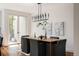 Dining area with sleek light fixture, stylish chairs, and direct access to the back deck at 3130 Wyandot St, Denver, CO 80211