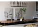 Close up of dining area with a decorative light fixture, table decorations, and modern artwork at 3130 Wyandot St, Denver, CO 80211