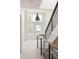 Bright entryway with modern staircase, large windows, and contemporary lighting fixture at 3130 Wyandot St, Denver, CO 80211
