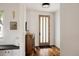 Inviting entryway with hardwood floors, a stylish console, and a frosted glass front door at 3130 Wyandot St, Denver, CO 80211