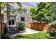 Landscaped exterior featuring a well-maintained lawn, stone path, and stylish fencing at 3130 Wyandot St, Denver, CO 80211