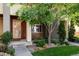 A charming home exterior featuring a well-manicured lawn, steps to front door, and mature tree at 3130 Wyandot St, Denver, CO 80211