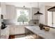 Bright kitchen features modern cabinetry, marble countertops, and designer finishes at 3130 Wyandot St, Denver, CO 80211