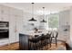 Bright kitchen with a large island, modern appliances, and stylish pendant lighting at 3130 Wyandot St, Denver, CO 80211