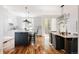 Open kitchen with an island and a dining area with modern light fixture and access to the back deck at 3130 Wyandot St, Denver, CO 80211