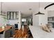 Open-concept kitchen and dining area featuring wood floors and high-end appliances and marble backsplash at 3130 Wyandot St, Denver, CO 80211