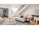 Inviting living room with a modern sofa, stylish decor, and an open staircase at 3130 Wyandot St, Denver, CO 80211