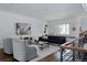 Open-concept living room featuring hardwood floors, large windows, and modern decor at 3130 Wyandot St, Denver, CO 80211