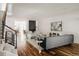 Open-concept living room with hardwood floors, a modern fireplace, and staircase with metal railings at 3130 Wyandot St, Denver, CO 80211