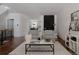 Stylish living room with hardwood floors, modern furnishings, and an open view to the kitchen at 3130 Wyandot St, Denver, CO 80211