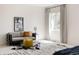 Cozy sitting area in the primary bedroom, featuring stylish decor and ample natural light at 3130 Wyandot St, Denver, CO 80211