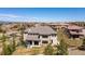 Aerial view of the stone-clad luxury home, situated in an upscale community with mountain views at 10704 Flowerburst Ct, Highlands Ranch, CO 80126