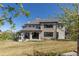 Large backyard with playset and covered patio; showcasing the stone and stucco exterior of the residence at 10704 Flowerburst Ct, Highlands Ranch, CO 80126
