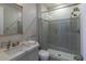 Bathroom featuring a walk-in shower, glass shelving, and modern fixtures at 10704 Flowerburst Ct, Highlands Ranch, CO 80126