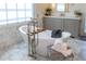 Bright bathroom featuring a soaking tub, marble flooring, and updated cabinets at 10704 Flowerburst Ct, Highlands Ranch, CO 80126